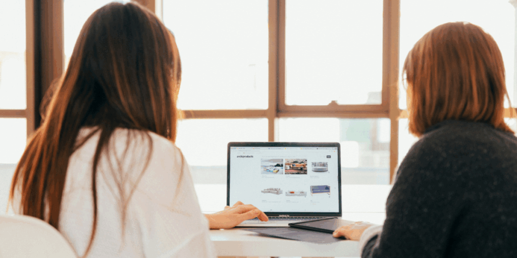 Colleagues looking at customer care platform on laptop together